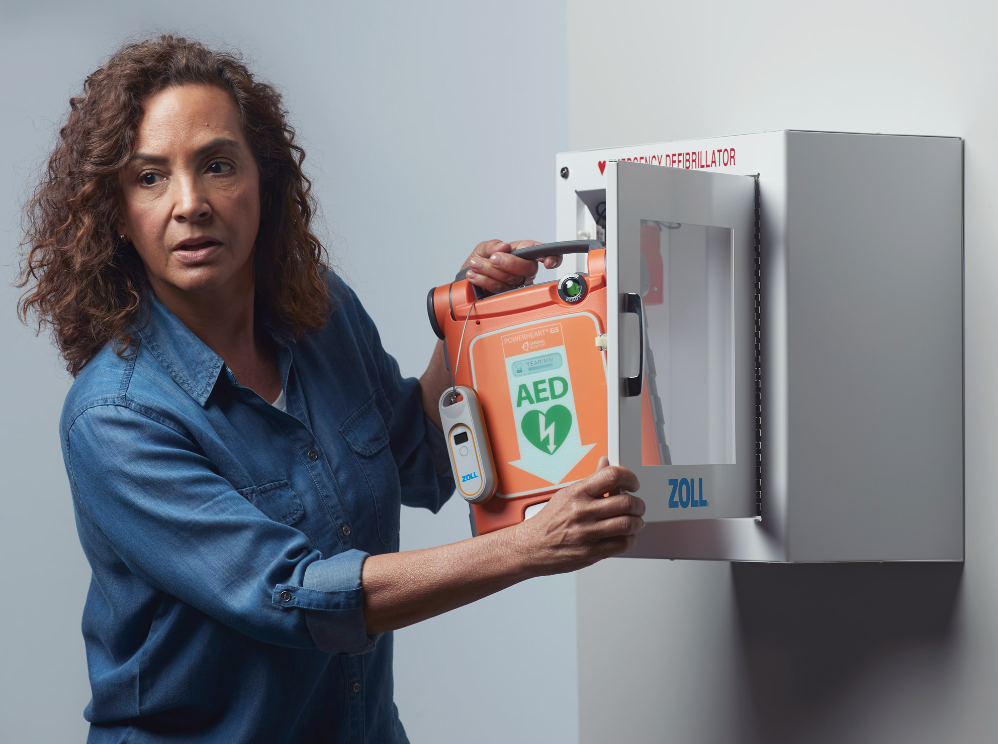 The Cardiac Science G5 AED being retrieved from its cabinet